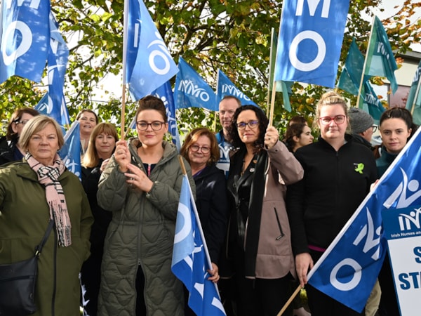Members protesting at a safe staffing protest holding INMO flags
